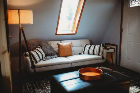 Small loft space with chair, lamp, and table in a Fairbanks Alaska vacation rental