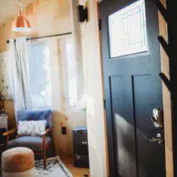 Inviting Fairbanks treehouse interior with hammock, teal sofa, cozy rug, and natural wood decor