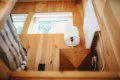 Wood-paneled treehouse interior with modern lamp and natural light in Fairbanks Alaska