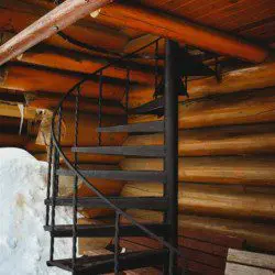 Close-up of log cabin treehouse exterior with window and hanging chains in Fairbanks Alaska