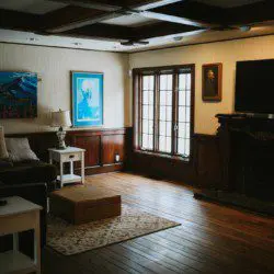 Warm living room with wood floors, fireplace, and natural light in a Fairbanks Alaska adventure lodge