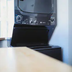 Stacked washer and dryer unit in modern Fairbanks Alaska treehouse rental