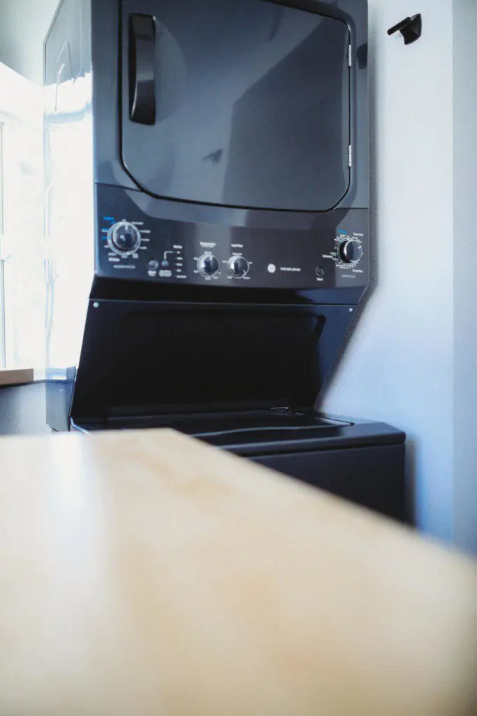 Stacked washer and dryer unit in modern Fairbanks Alaska treehouse rental
