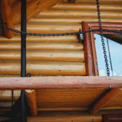 Close-up of log cabin treehouse exterior with window and hanging chains in Fairbanks Alaska