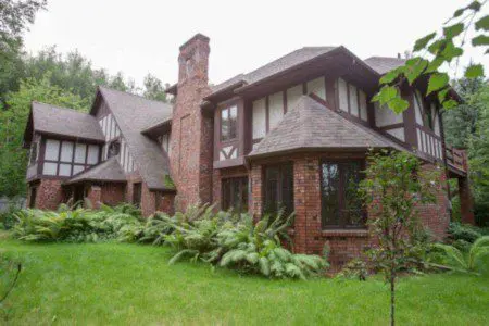 Brick and timber Tudor-style lodge surrounded by greenery in Fairbanks Alaska