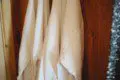 Two soft white robes hanging on wooden wall in a Fairbanks Alaska lodge or treehouse rental