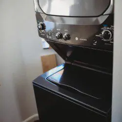 Compact stacked washer and dryer inside Fairbanks Alaska treehouse rental
