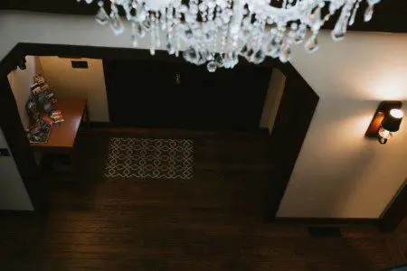 Overhead view of wooden lodge entryway with crystal chandelier in a Fairbanks Alaska adventure lodge