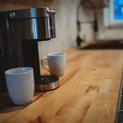 Coffee maker with two white mugs on a wooden counter in a Fairbanks Alaska treehouse kitchen