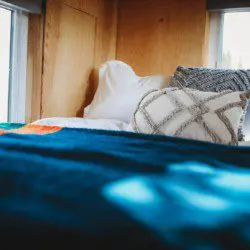 Comfy bed with pillows and soft blanket inside a Fairbanks Alaska treehouse rental
