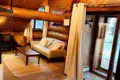 Overhead view of cozy log cabin-style living room with sofa and chairs in Fairbanks Alaska treehouse