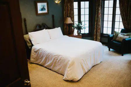 Cozy lodge bedroom in Fairbanks Alaska with elegant decor and natural light, ideal for weddings or unique stays