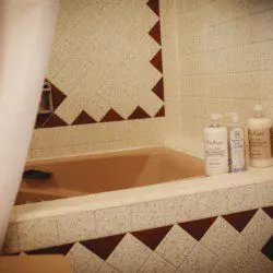 Close-up of tiled bathtub with natural bath products in a Fairbanks Alaska treehouse rental