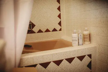 Close-up of tiled bathtub with natural bath products in a Fairbanks Alaska treehouse rental