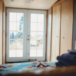 Comfy bed with pillows and soft blanket inside a Fairbanks Alaska treehouse rental