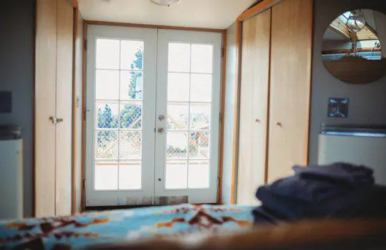 Comfy bed with pillows and soft blanket inside a Fairbanks Alaska treehouse rental