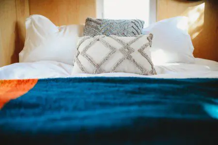 Comfy bed with pillows and soft blanket inside a Fairbanks Alaska treehouse rental