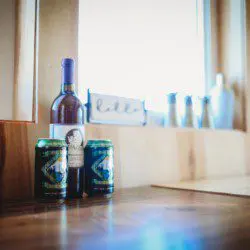 Wine bottle and canned drinks on wooden counter near window in a Fairbanks Alaska treehouse rental