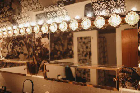 Black soaking bathtub with tiled backsplash in a Fairbanks Alaska treehouse bathroom