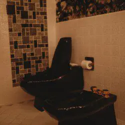 Black soaking bathtub with tiled backsplash in a Fairbanks Alaska treehouse bathroom
