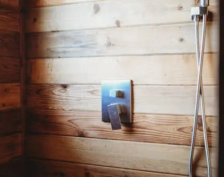 Enjoy a warm shower in this rustic wood-paneled bathroom—perfect for relaxing after Alaska adventures or wedding celebrations.