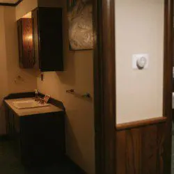 Vintage-style sink and cabinet area in a cozy Fairbanks Alaska rental with wood accents