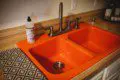 Bright orange dual kitchen sink with modern faucet and dish soap in a Fairbanks Alaska treehouse rental