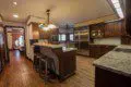 Large kitchen with granite counters, wood cabinets, and stainless appliances in a Fairbanks Alaska lodge