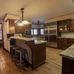 Large kitchen with granite counters, wood cabinets, and stainless appliances in a Fairbanks Alaska lodge