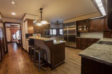 Large kitchen with granite counters, wood cabinets, and stainless appliances in a Fairbanks Alaska lodge