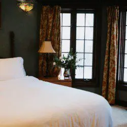 Cozy lodge bedroom in Fairbanks Alaska with elegant decor and natural light, ideal for weddings or unique stays