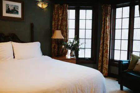 Cozy lodge bedroom in Fairbanks Alaska with elegant decor and natural light, ideal for weddings or unique stays