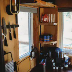  Coffee station, shelves, and kitchen knives in a well-stocked Fairbanks Alaska treehouse rental