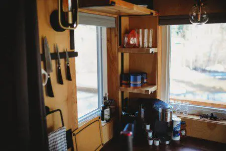 Coffee station, shelves, and kitchen knives in a well-stocked Fairbanks Alaska treehouse rental