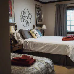 Cozy lodge bedroom in Fairbanks Alaska with elegant decor and natural light, ideal for weddings or unique stays