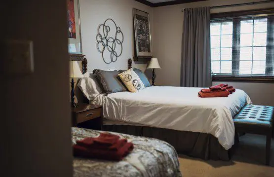 Cozy lodge bedroom in Fairbanks Alaska with elegant decor and natural light, ideal for weddings or unique stays