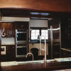 High-end kitchen with wood cabinetry, stainless appliances, and large sink area in a Fairbanks Alaska lodge