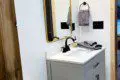 Contemporary bathroom with white vanity, black faucet, and wood accents in a Fairbanks Alaska rental