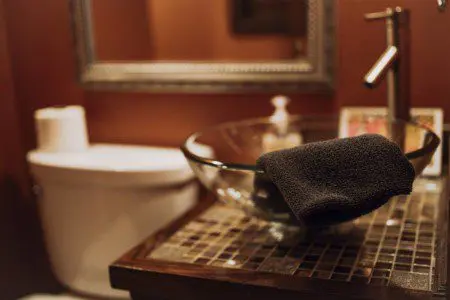Modern rustic bathroom with glass vessel sink and mosaic countertop in a Fairbanks Alaska adventure lodge