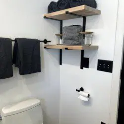 Glass-enclosed shower with marble-style tile in a modern Fairbanks treehouse bathroom