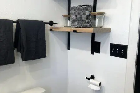 Glass-enclosed shower with marble-style tile in a modern Fairbanks treehouse bathroom