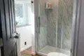 Bright bathroom with glass walk-in shower and natural light in a Fairbanks Alaska treehouse rental