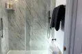 Treehouse bathroom with marble walk-in shower and black fixtures in Fairbanks, Alaska