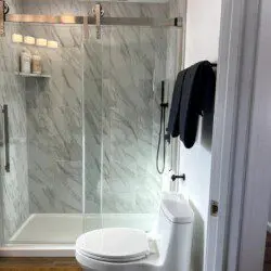 Treehouse bathroom with marble walk-in shower and black fixtures in Fairbanks, Alaska