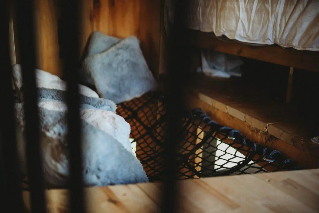 Netted loft area with soft pillows in a cozy treehouse rental in Fairbanks Alaska
