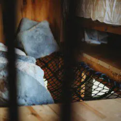 Netted loft area with soft pillows in a cozy treehouse rental in Fairbanks Alaska