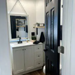 Compact and modern bathroom with black and white accents in a Fairbanks treehouse rental