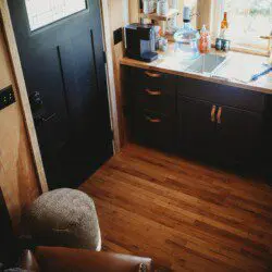 Warm wood kitchen with black cabinets and natural light in a Fairbanks Alaska treehouse rental