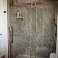 Treehouse bathroom with marble walk-in shower and black fixtures in Fairbanks, Alaska