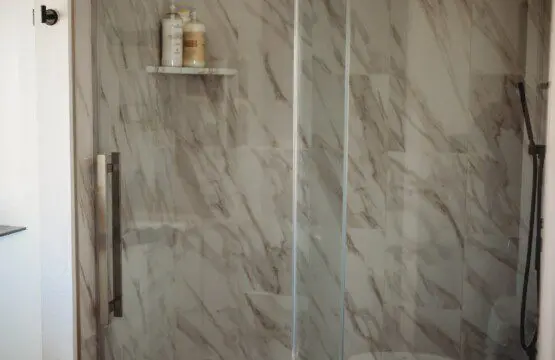 Treehouse bathroom with marble walk-in shower and black fixtures in Fairbanks, Alaska